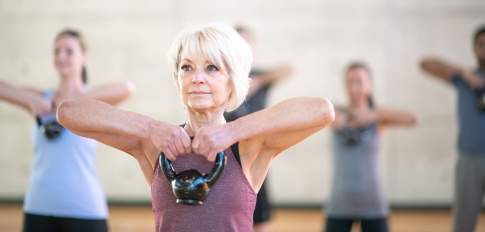 Middle age woman exercising holding up weight