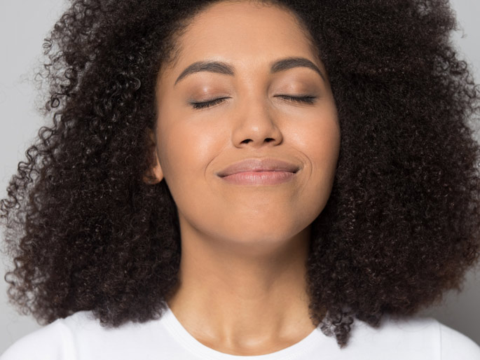 Woman peaceful inhaling with eyes closed